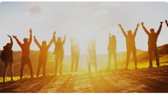 Employees standing together with sunlight shining above