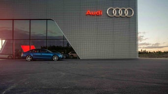 Side view of parked Audi vehicle. 