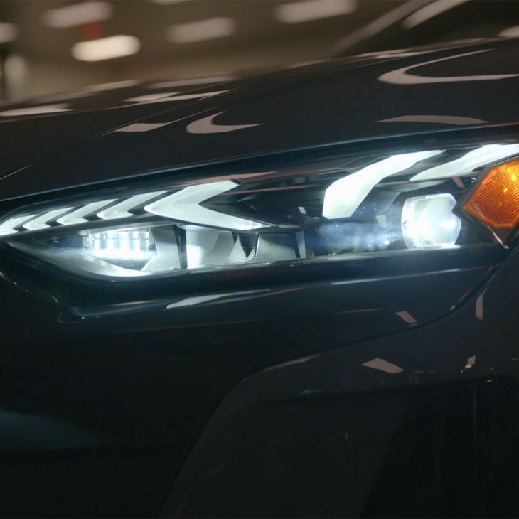 Close up on the headlights of an Audi vehicle.