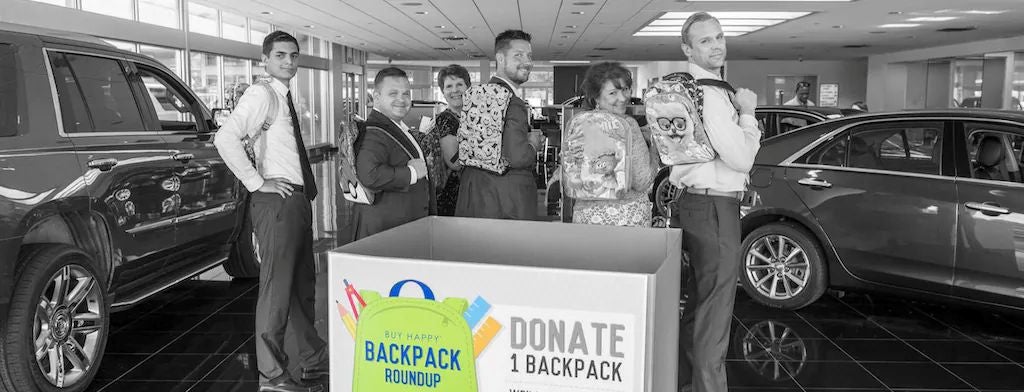 Audi employee handing a set of car keys to a customer.