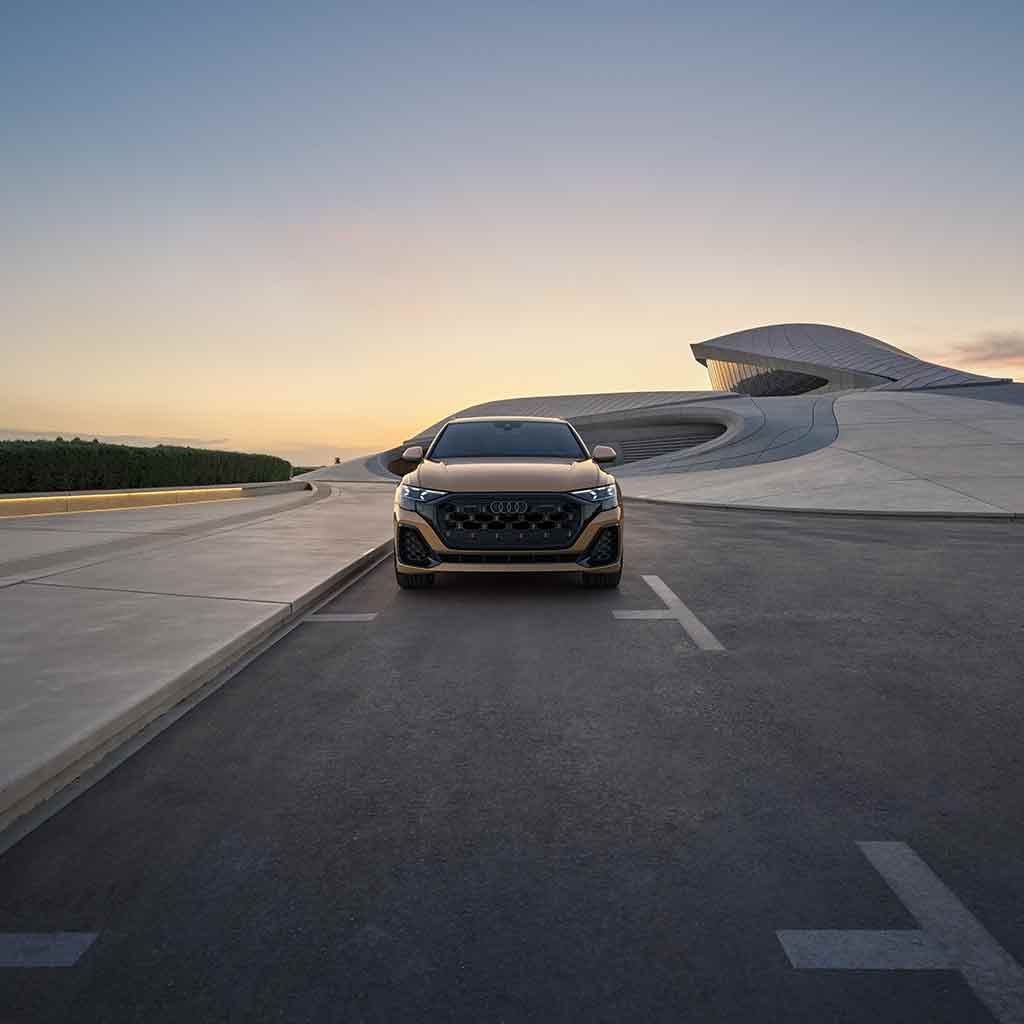 Front profile view of an Audi Q8 accelerating.