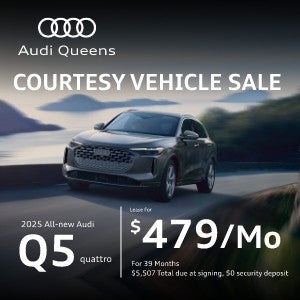 Front left view of an Audi Q5 driving.