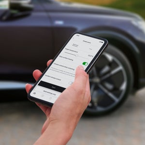 Close-up on a smartphone displaying the Comfort pre-conditioning options in the myAudi app .
