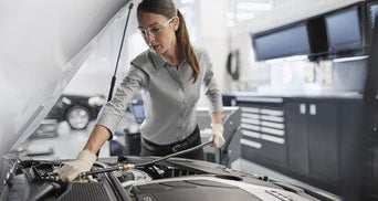 mechanic checking coolant 