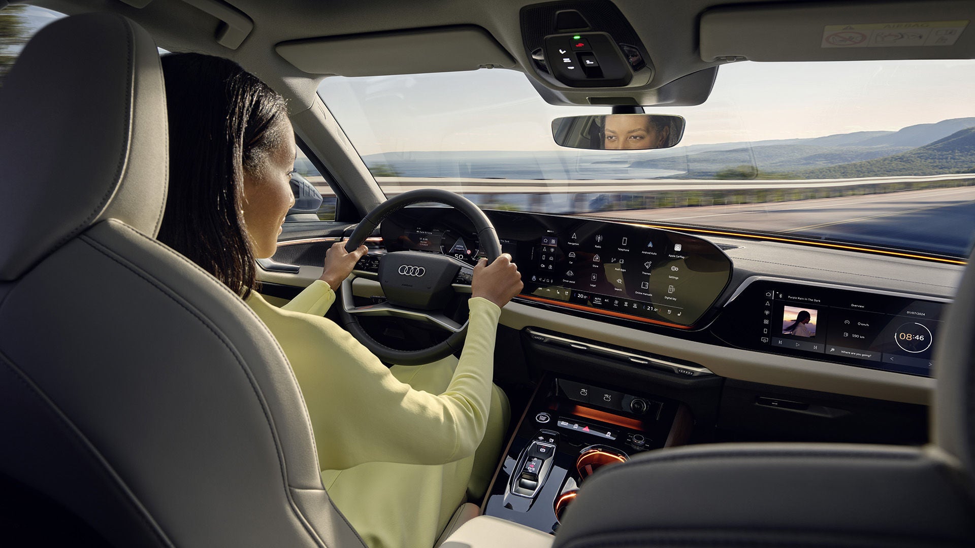 Person in a driver's seat of an Audi Vehicle