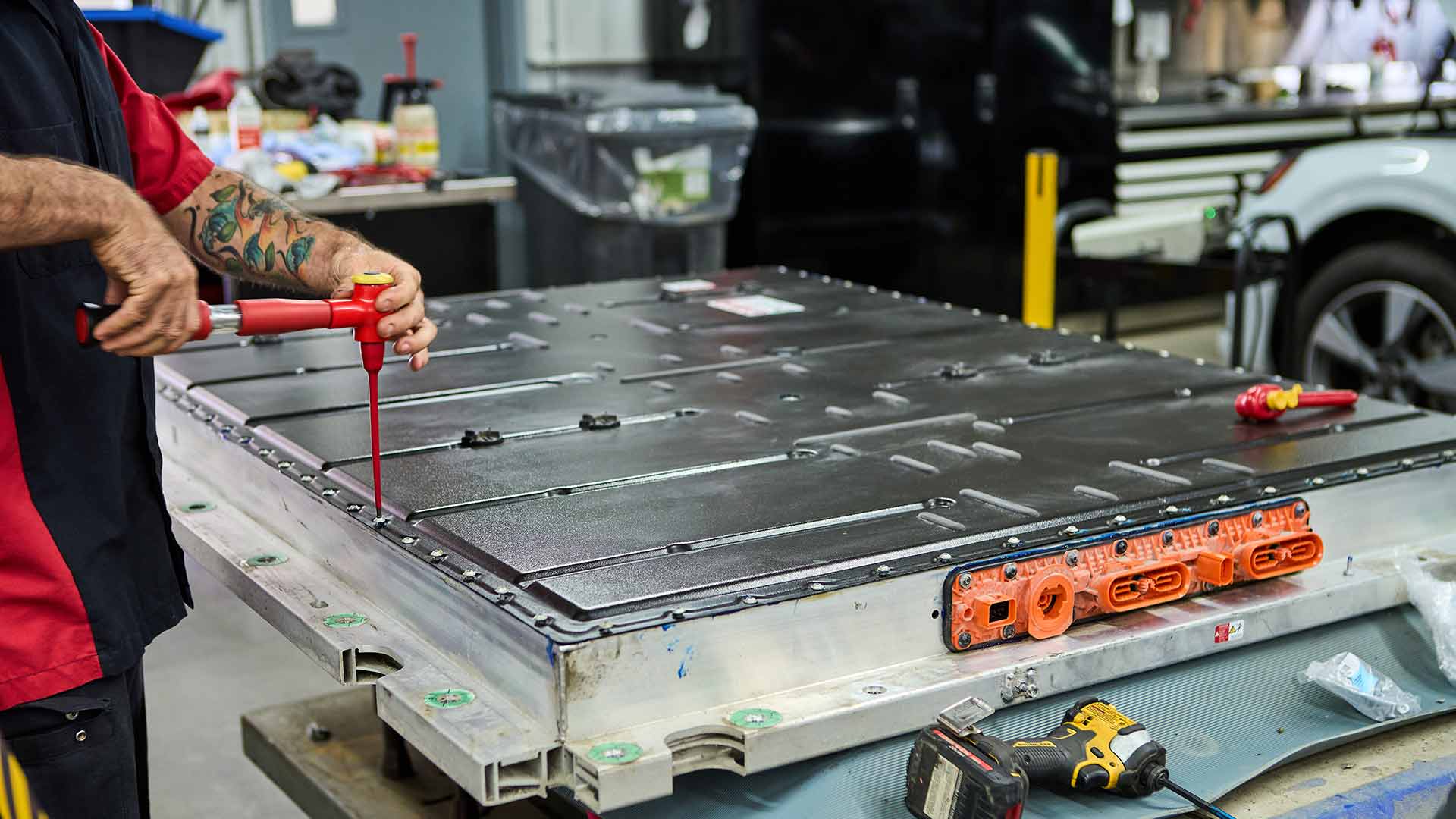 Audi service technician servicing a vehicle.