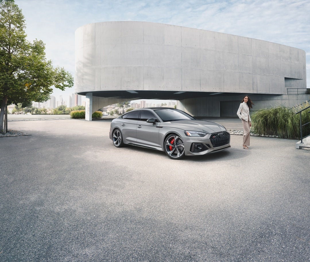 Audi S5 parked with owner standing by