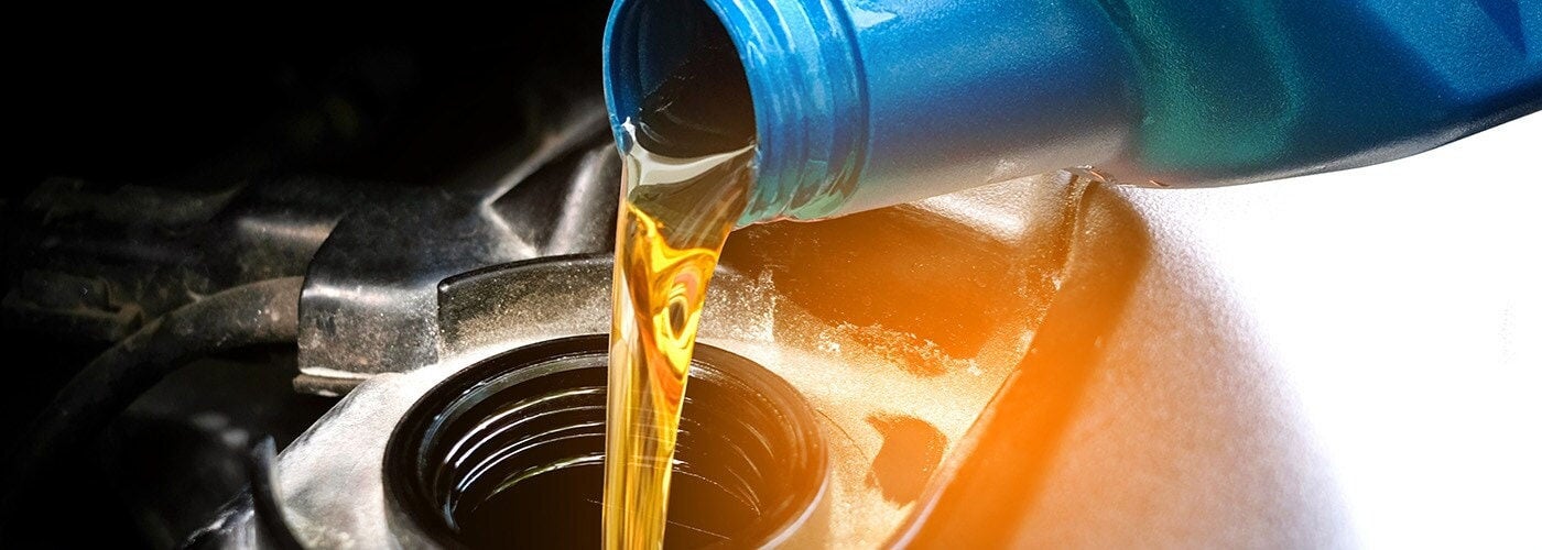 New motor oil poured into filter
