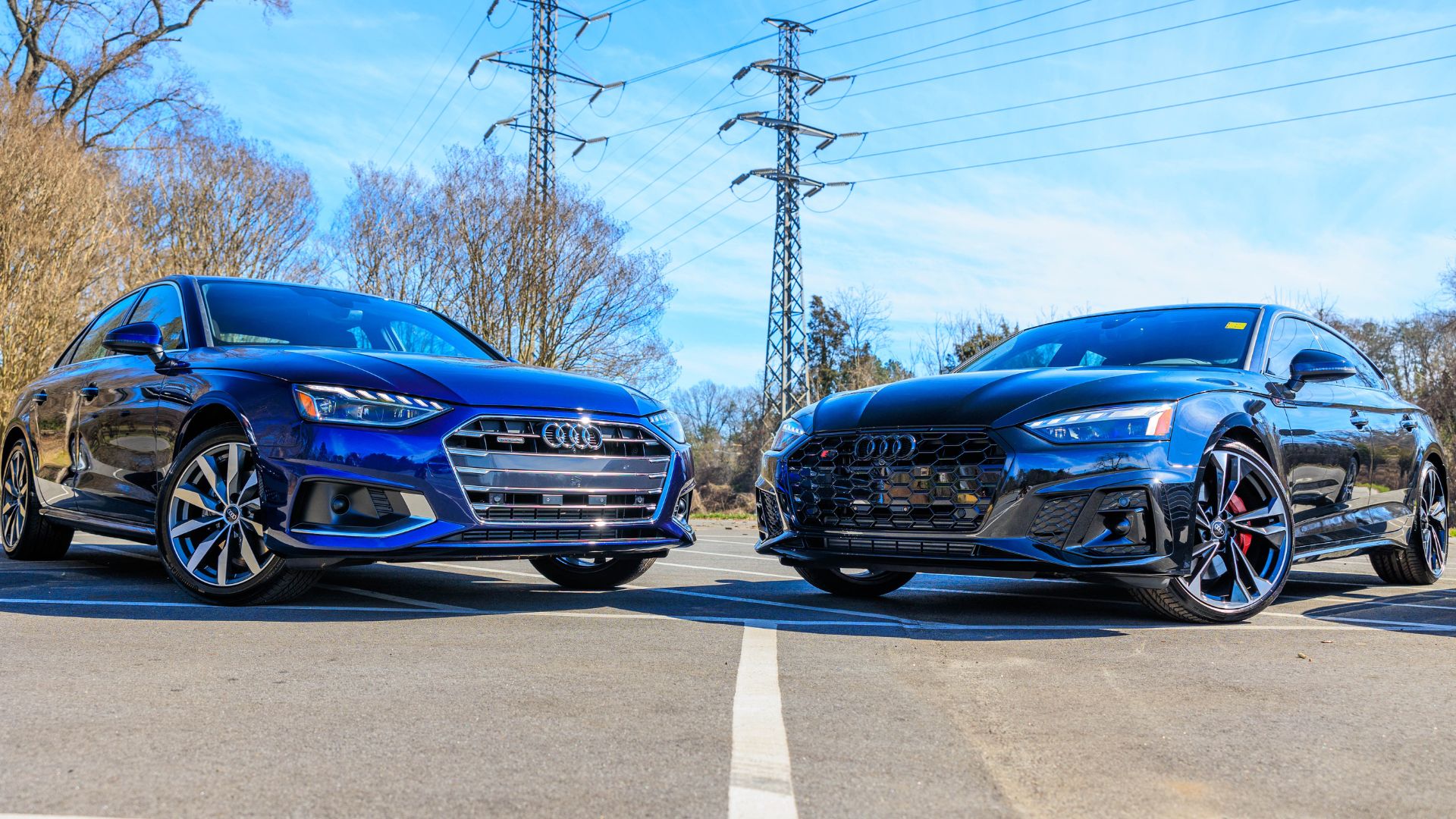 Two Audi sedans parked next to each other and facing the camera