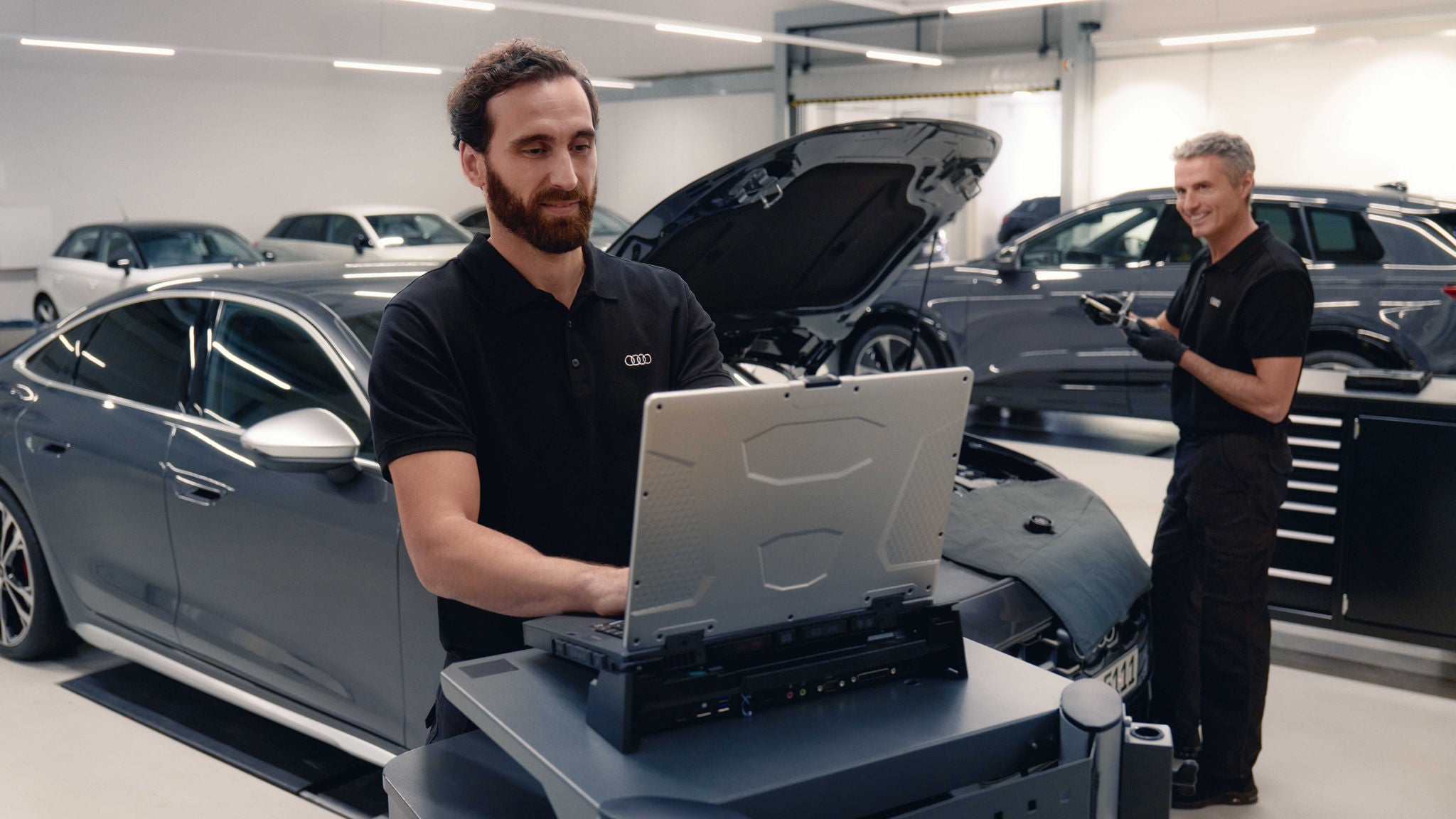 Audi service technician servicing a vehicle.