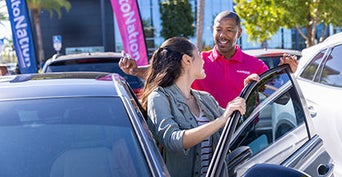 Dealership representative talking to a customer.