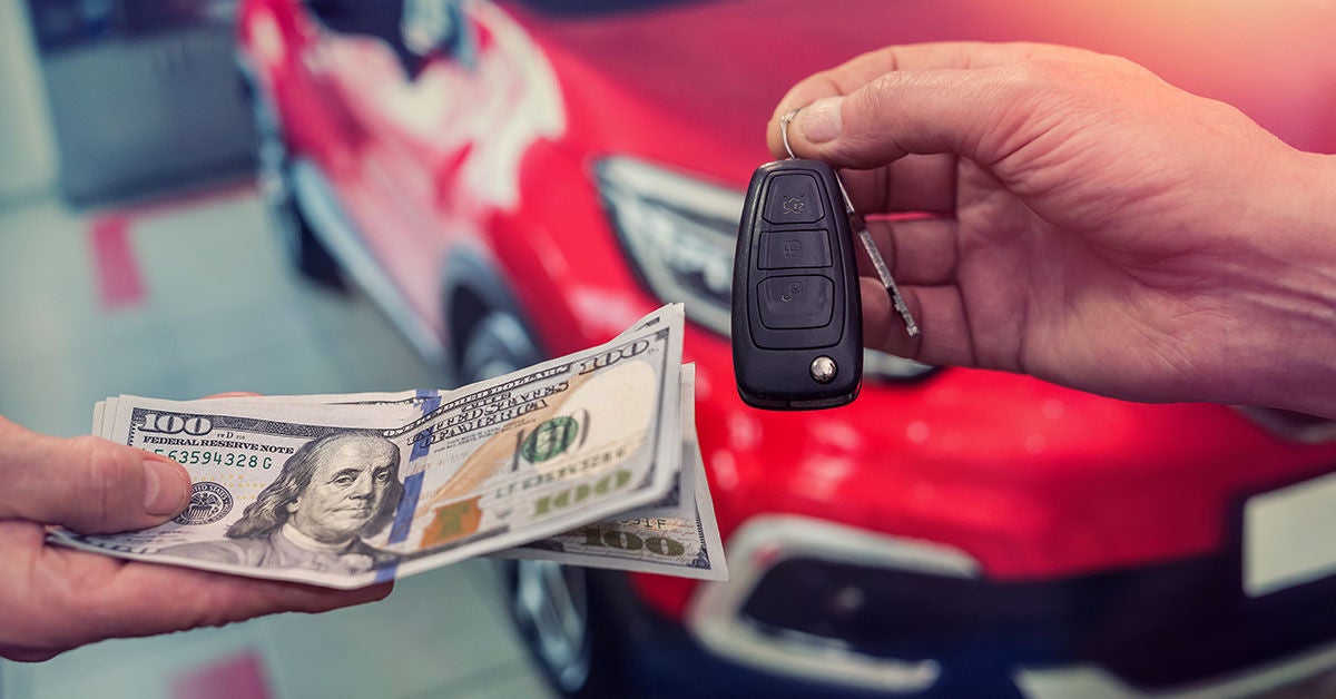 Cash and keys exchanging hands as part of Audi trade-in
