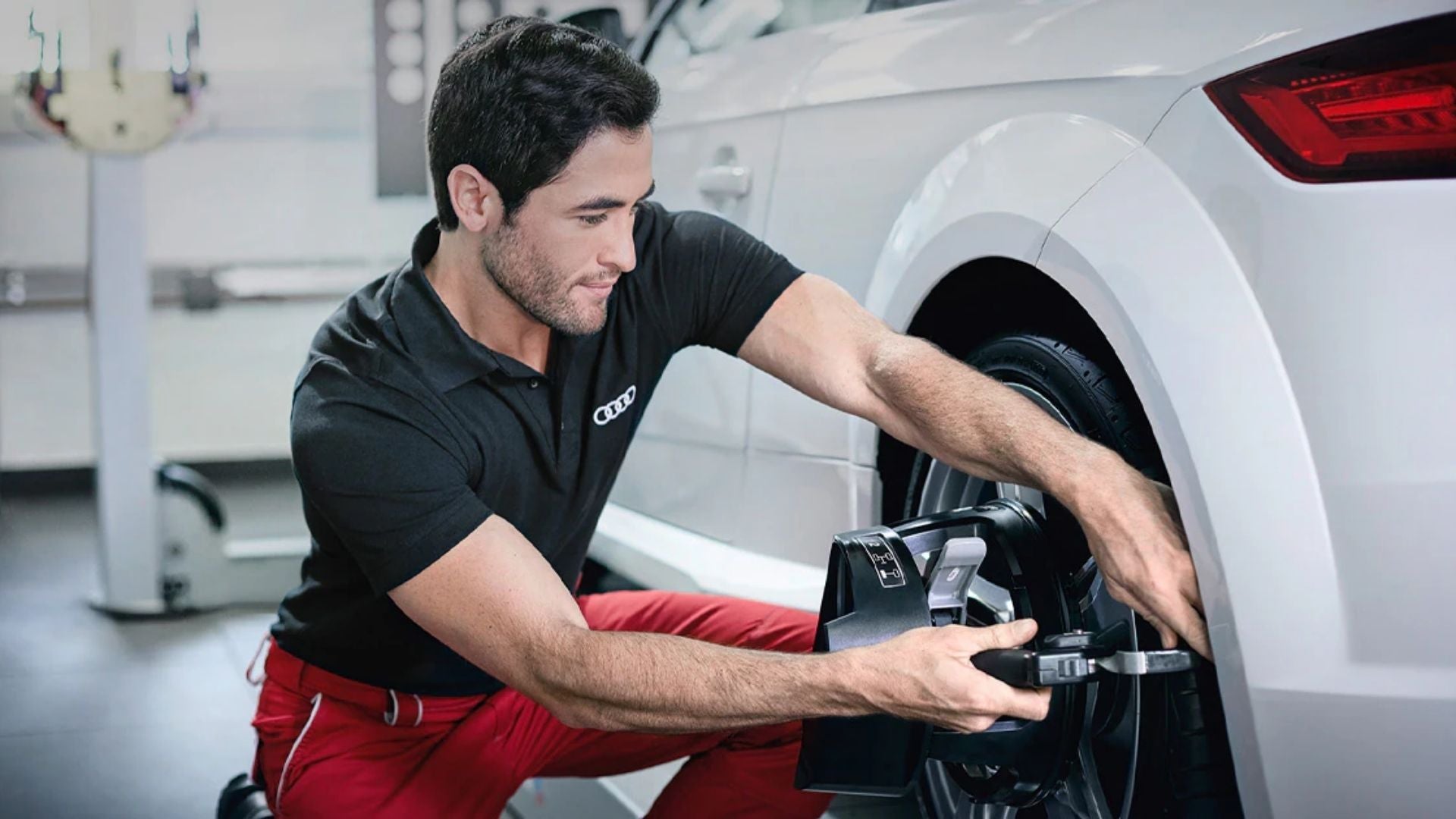 audi tech working on wheel
