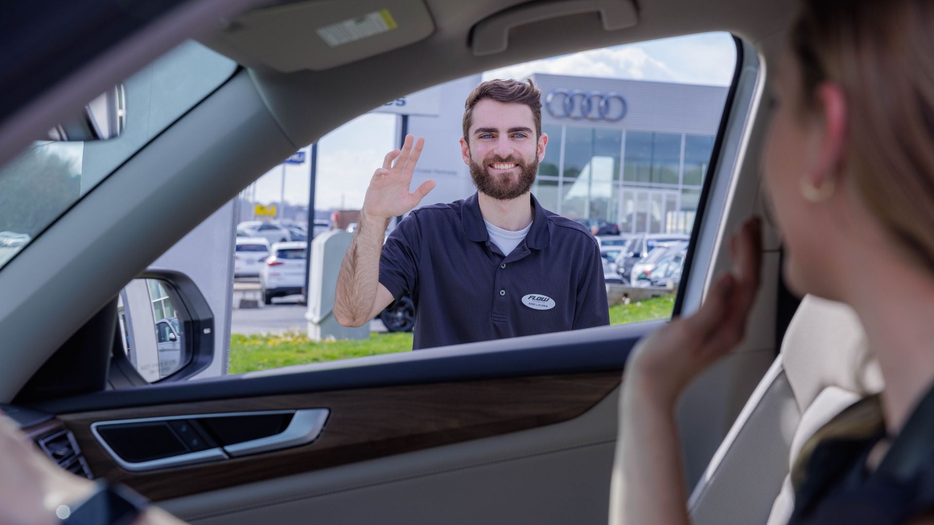 Audi employee greeting a customer.