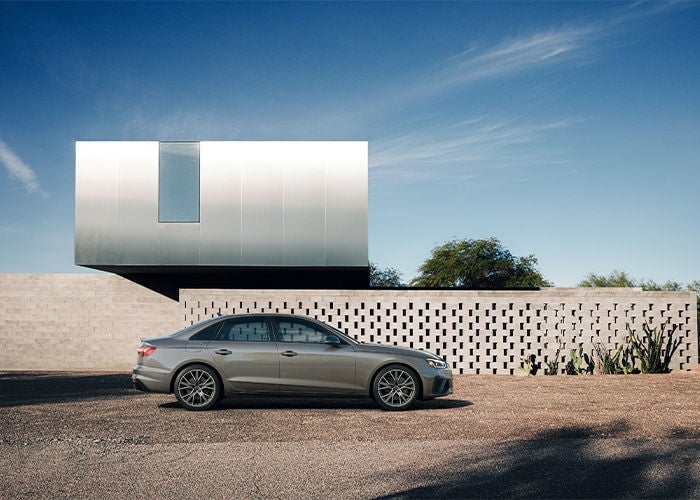 Audi A4 parked in front of solar panels