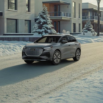Audi Q4 e-tron equipped with winter tires parked on a snow-covered road