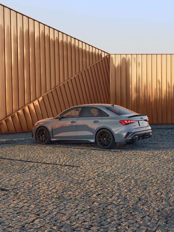 2025 Audi RS 3 rear three-quarter — dual oval RS exhaust + integrated rear diffuser