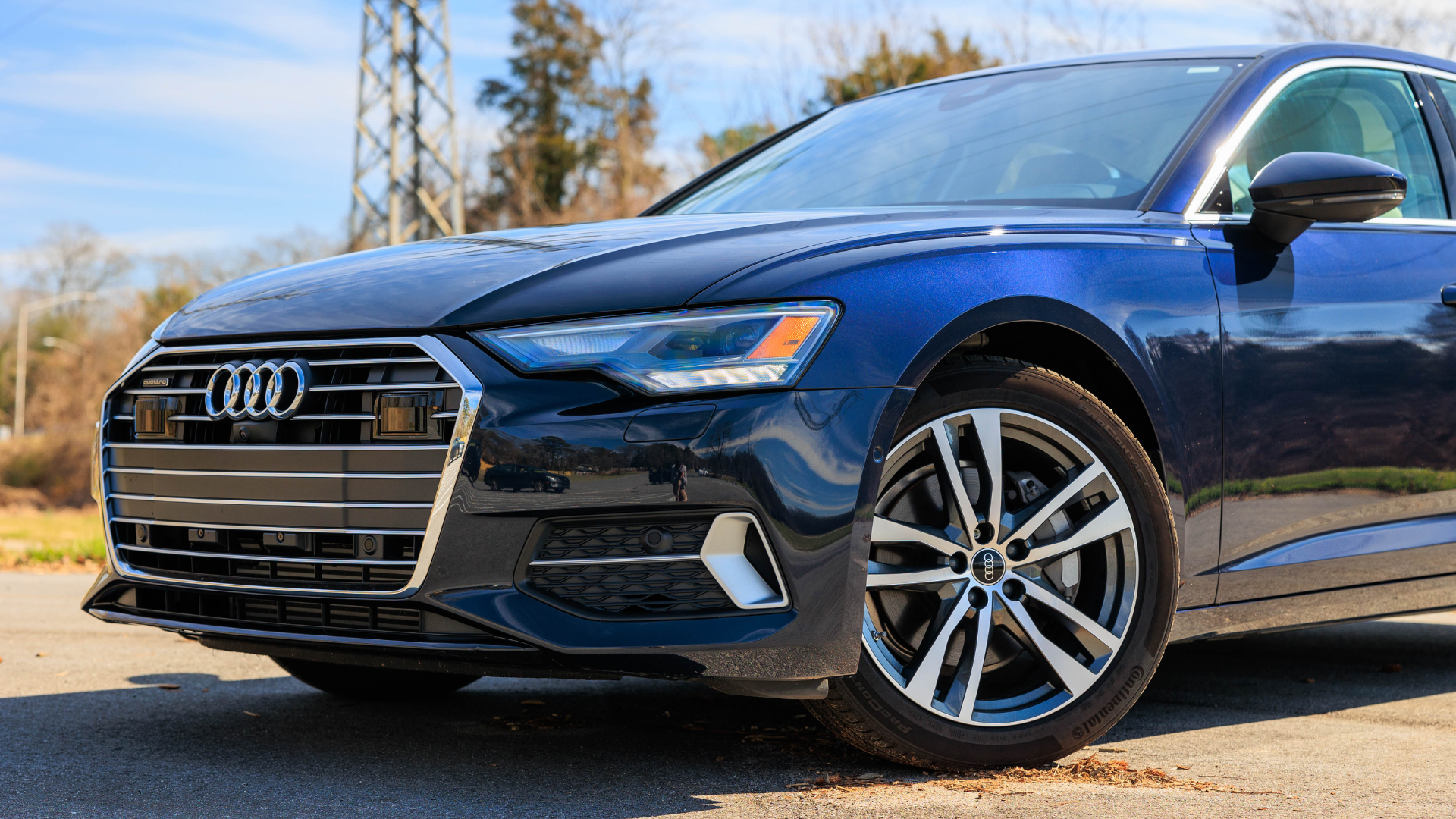Close up of the front of a dark blue Audi sedan