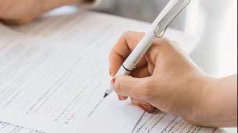 Customer signing the papers.