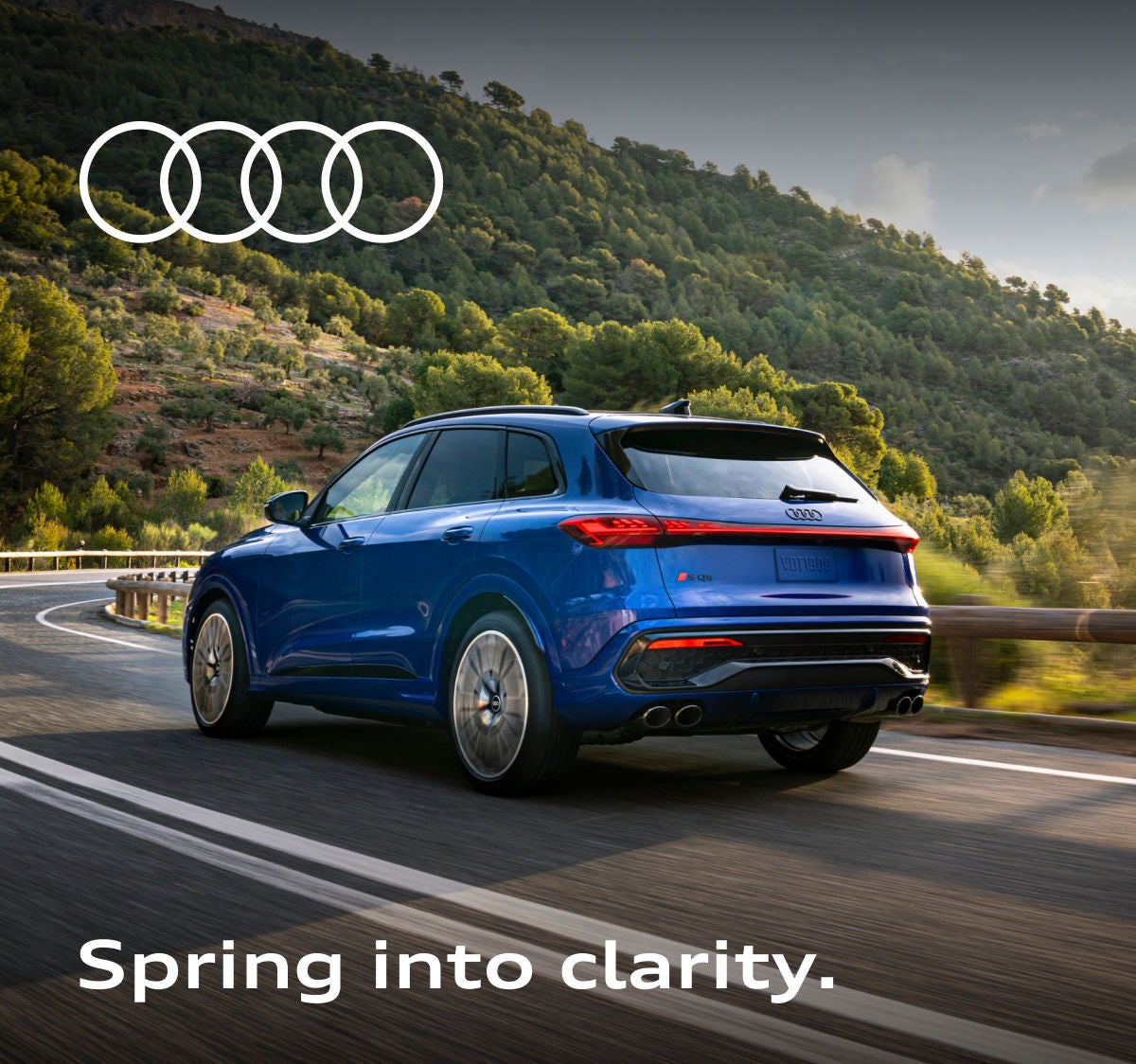 Blue Audi SQ5 driving down the road. 