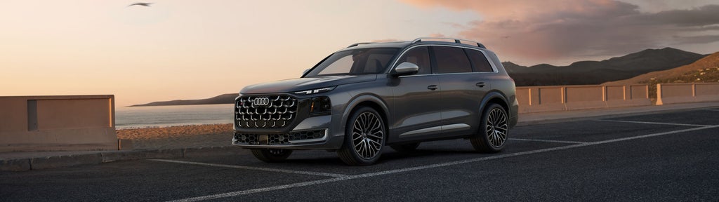 Three-quarter side-view of the Audi SQ9 parked on a waterfront.