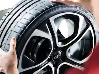 Service technician servicing tire.