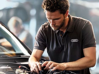 Service technician serving vehicle.