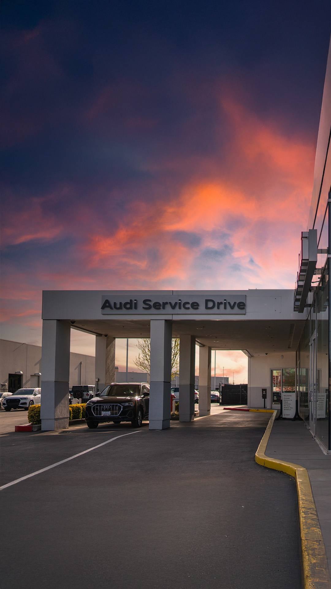 The Audi Service Drive entrance at Audi Elk Grove at dusk
