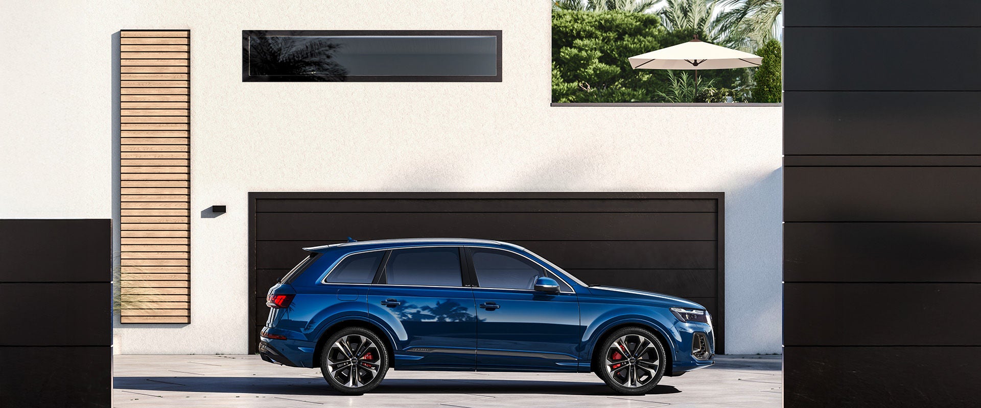 2026 Audi Q7 in blue parked infront of a modern house