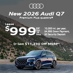 Side view of an Audi Q7 driving.