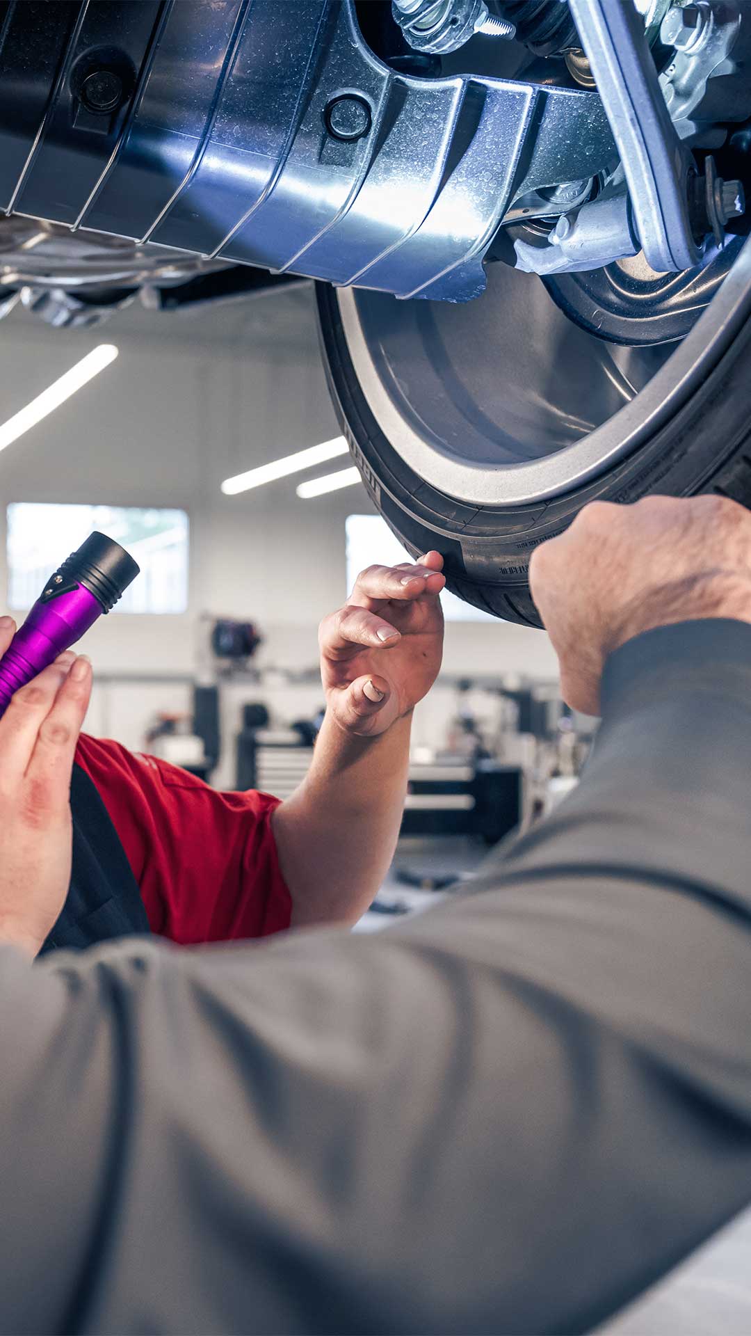 Audi service technician inspecting a vehicle