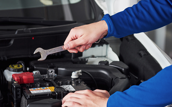 Service technician serving vehicle.