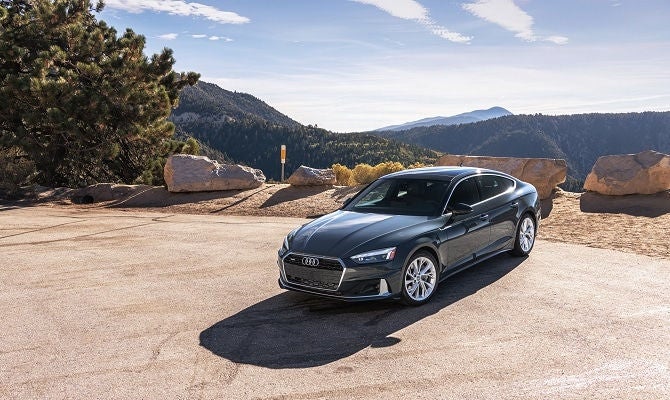 Audi A5 parked in front of mountain