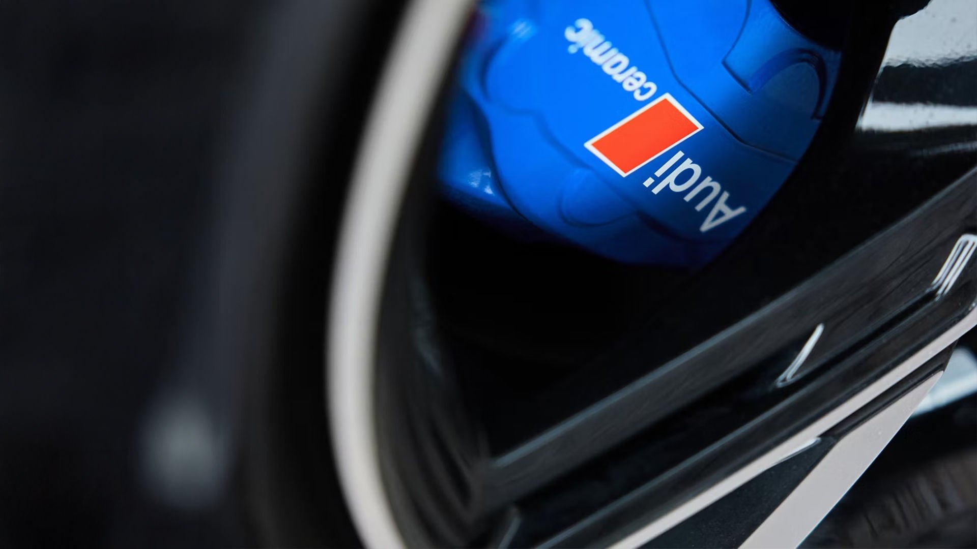 Audi service technician servicing a vehicle.