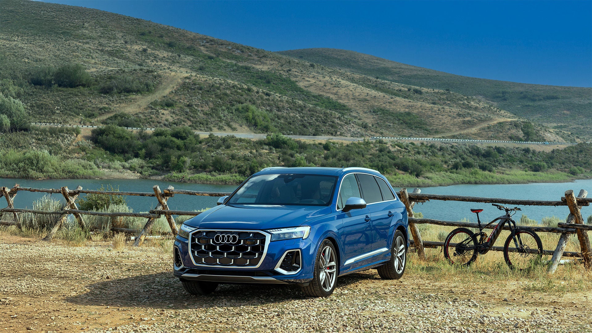 2026 Audi Q7 bike rack on back of blue trim parked by a lake