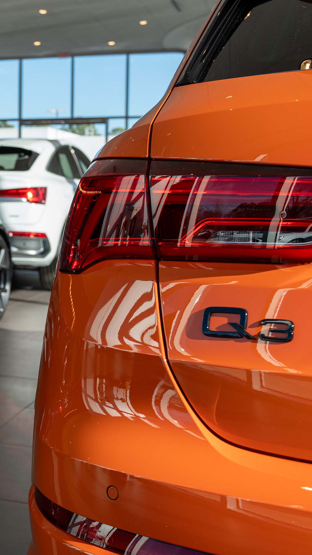 Rear profile view of an Audi Q3 parked.