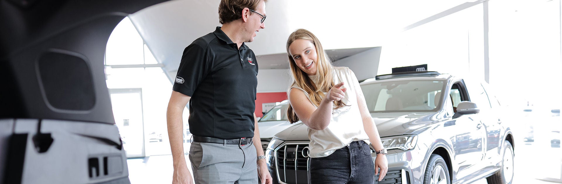 Audi Sale Specialist walking through the showroom with a couple.