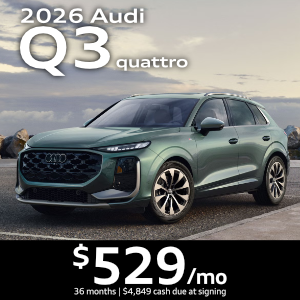 Side view of an Audi Q3 driving.