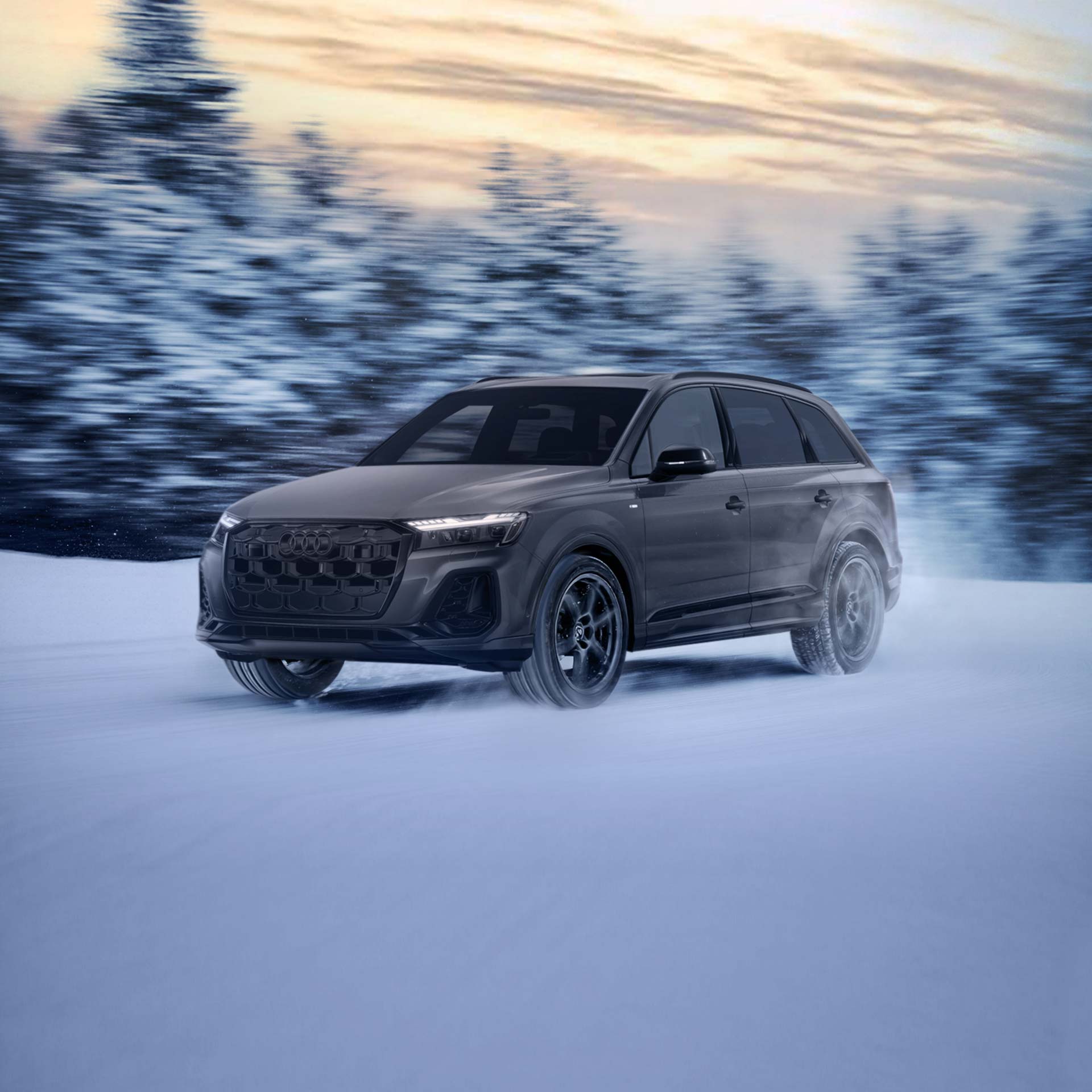 Three-quarter front profile of an Audi Q6 e-tron accelerating.