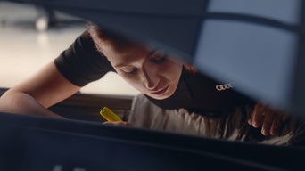 Audi Service technician servicing a vehicle.