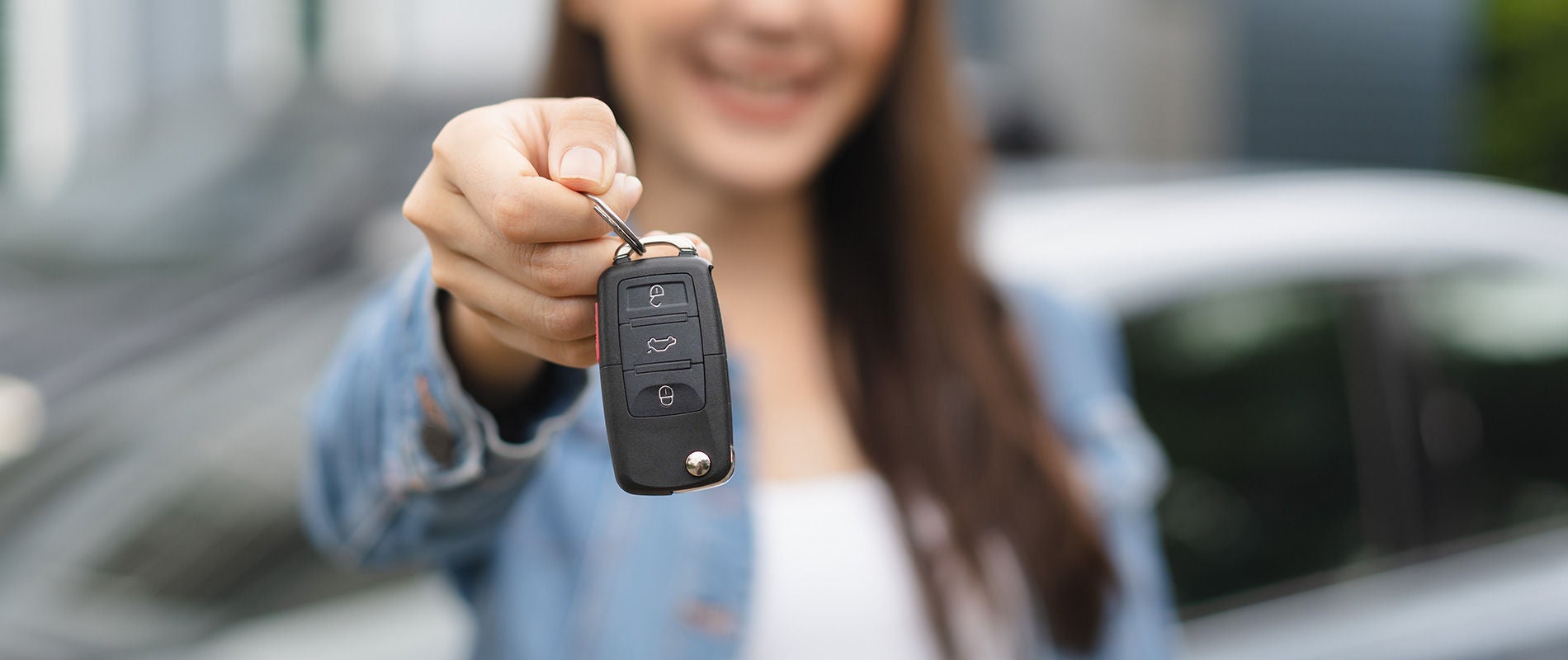 Woman showing off the keys to her used Audi