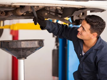 Service technician servicing vehicle.