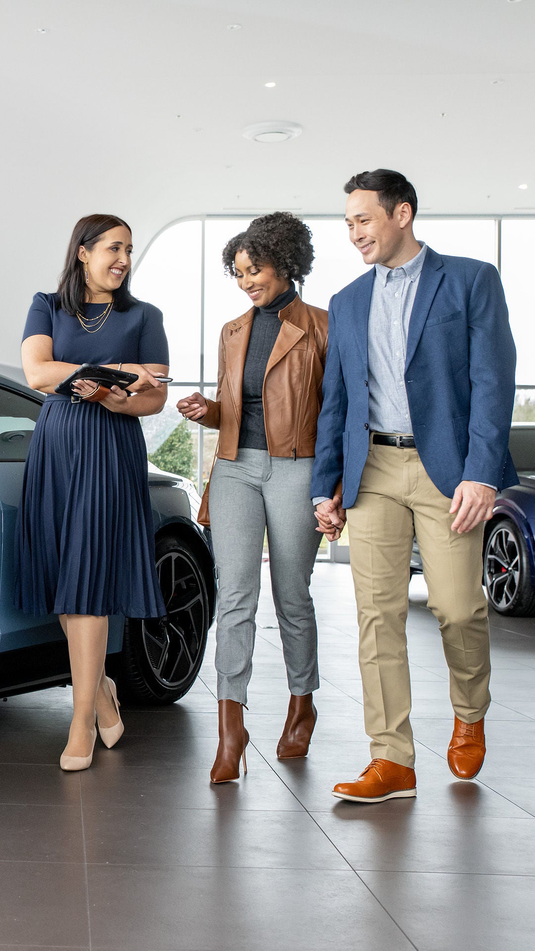 Sales rep showing customers a vehicle