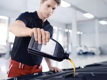 Service technician serving vehicle.