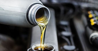 Service technician changing oil.