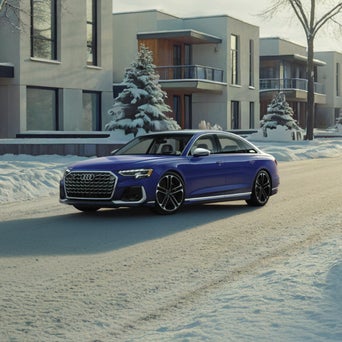 Audi A8 equipped with winter tires parked on a snow-covered road