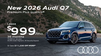 Side view of an Audi Q7 parked.