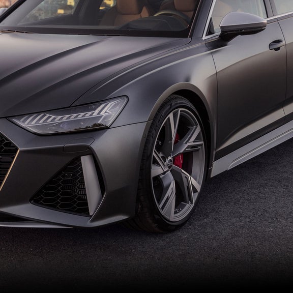 Three-quarter front view of a matte gray Audi RS 6 Avant.