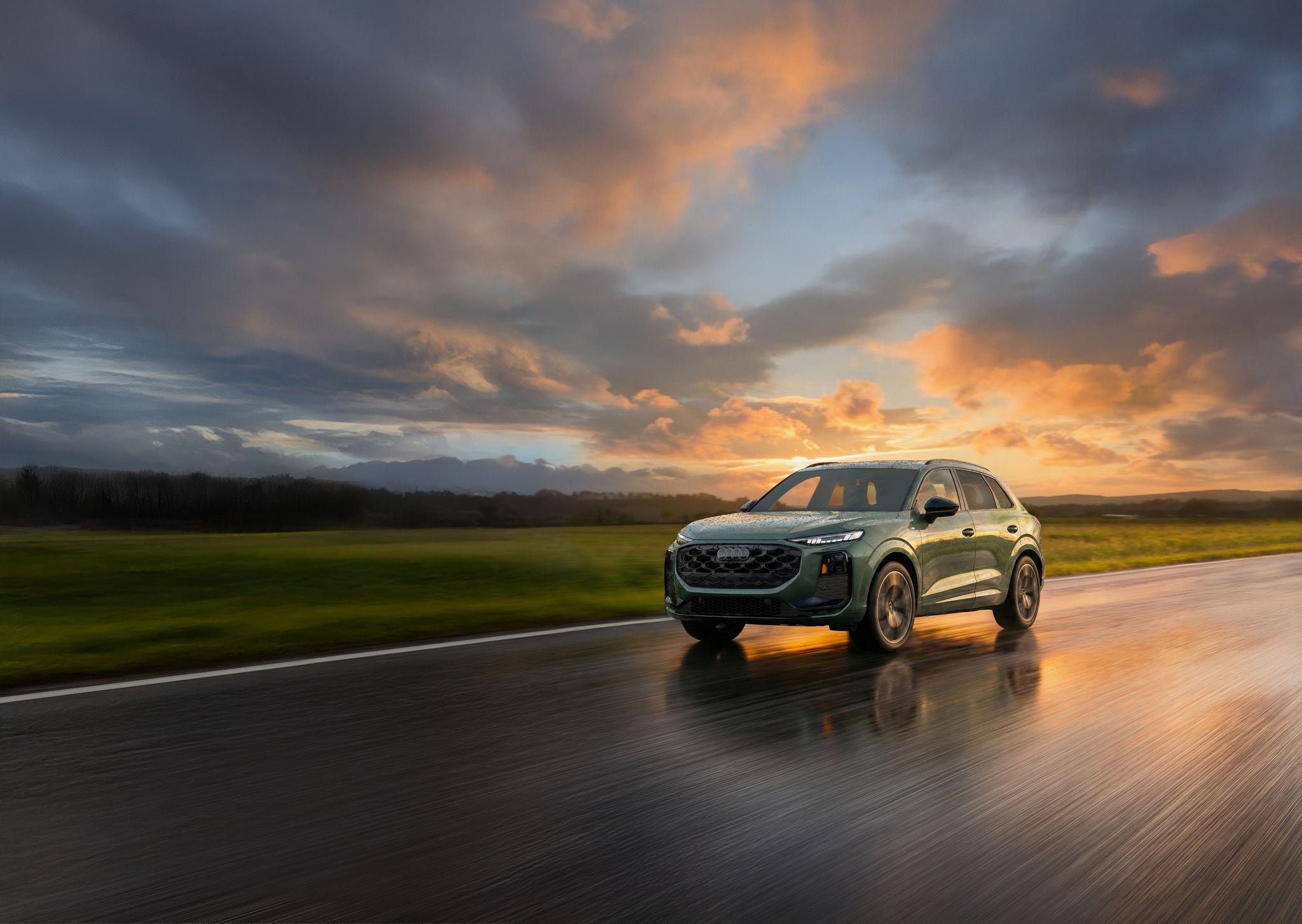 Three quarter profile view of an Audi Q3 accelerating.