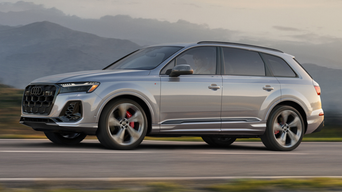 Left side profile of an Audi Q7 accelerating.